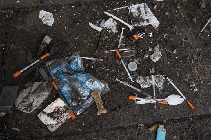 Used needles are seen on the street during a city sweep of a homeless encampment in New York City, Sept. 22, 2022